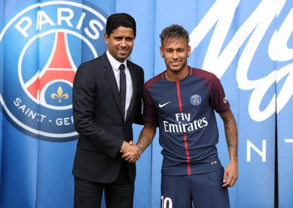 File photo dated 04-08-2017 of Neymar is unveiled alongside Paris Saint Germain president Nasser Al-Khelaifi during a press conference at the Parc des Princes, following his world record breaking Â£200million transfer from FC Barcelona to Paris Saint Germain. PRESS ASSOCIATION Photo. Issue date: Friday September 1, 2017. UEFA has announced it has opened a Financial Fair Play investigation into Paris St Germain. See PA story SOCCER Paris St Germain. Photo credit should read Jonathan Brady/PA Wire.