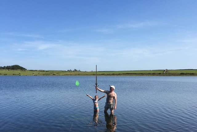 Matilda with dad Paul in the lake the sword was found.