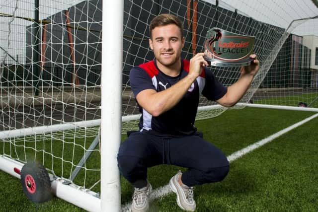 Lewis Vaughan, who has scored 13 goals in nine matches so far, shows off his League 1 Player of the Month trophy for August. Picture: SNS.