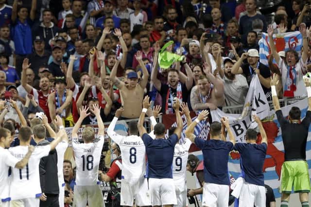 Luxembourg's players celebrate with the travelling fans after holding France to a draw in Toulouse. Picture: AP