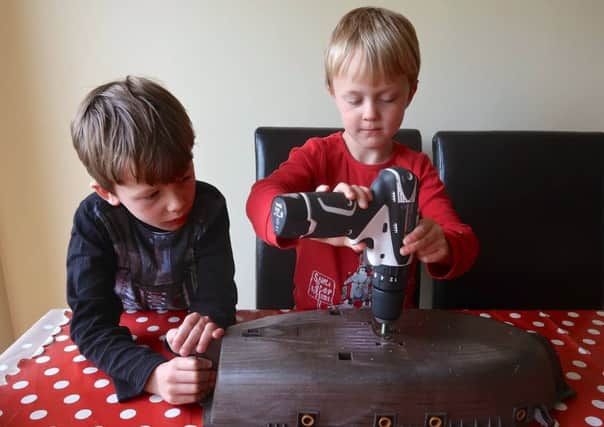 Eeight-year-old Ollie Ferguson and sibling Harry, five, preparing their toy pirate ship for the sea. Picture: Family handout/PA Wire