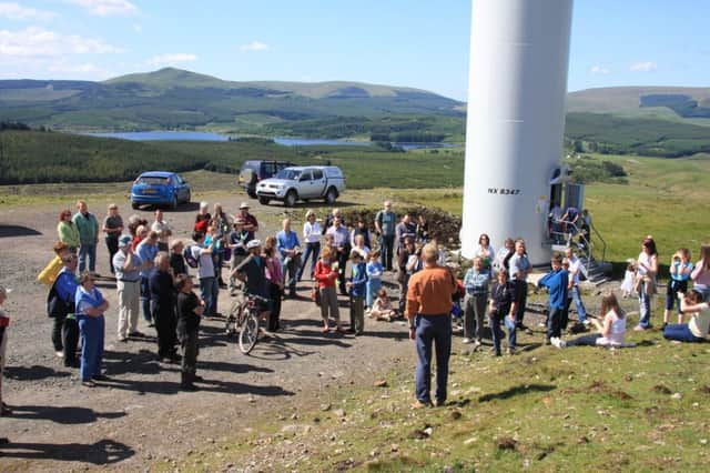 Members of the Stirlingshire village of Fintry turn out to see their new community turbine begin generating green electricity and cash for local initiatives. It has been bringing in around Â£50,000 a year for the past decade. Picture: Peter Skabara
