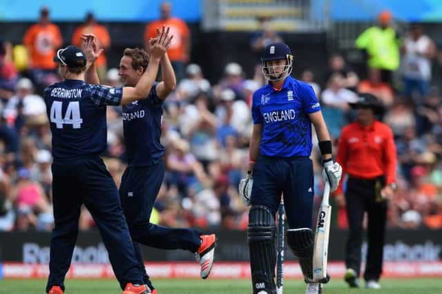 Josh Davey, centre, celebrates with Richie Berrington after dismissing Englands Joe Root in the clash between the sides in Christchurch at the 2015 Cricket World Cup. Picture: Shaun Botterill/Getty Images