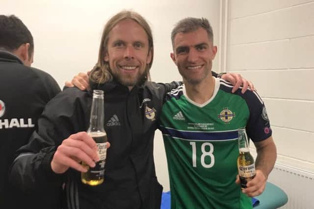 Austin MacPhee and Aaron Hughes celebrate Northern Ireland's win over Czech Republic.