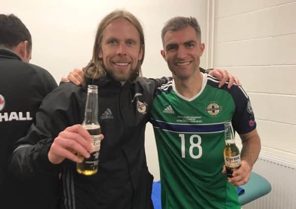 Austin MacPhee and Aaron Hughes celebrate Northern Ireland's win over Czech Republic.
