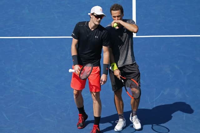 Jamie Murray speaks to partner Bruno Soares during their fourth round match against Jean-Julien Rojer of the Netherlands and Horia Tecau of Romania. Picture: Al Bello/Getty Images
