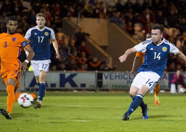 Stephen Mallan scores the second goal to seal Scotland Under-21s victory last night. Picture: SNS.