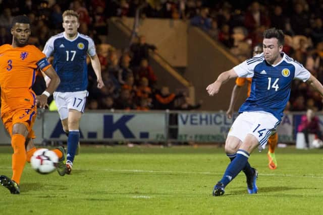 Stephen Mallan scores the second goal to seal Scotland Under-21s victory last night. Picture: SNS.