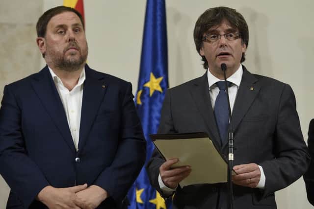 President of the Catalan Government Carles Puigdemont (right) makes a declaration after signing a decree calling independence referendum. Picture: AFP/Getty Images