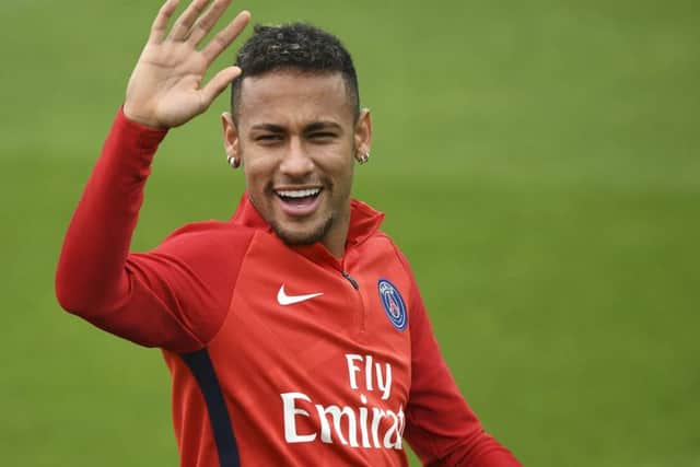 Neymar Jr. waves during a PSG training session. Shirts with his name on the back only just made the top 20. Picture: AFP/Getty Images