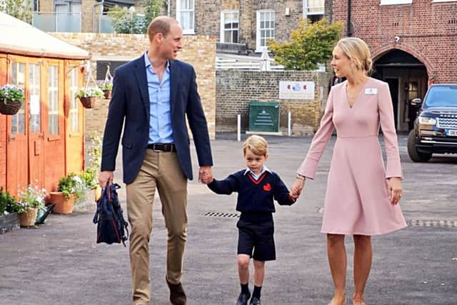 Prince George arrives at school holding hands with the Duke of Cambridge and Helen Haslem, head of the lower school, at Thomas's Battersea. Picture: PA