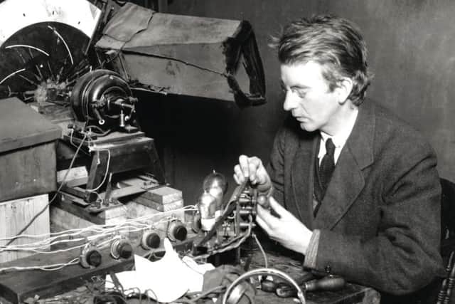 Scottish electrical engineer and inventor John Logie Baird (1888 - 1946) adjusting the transmitter of his new 'wireless vision' system, later known as television.   (Photo by Hulton Archive/Getty Images)
