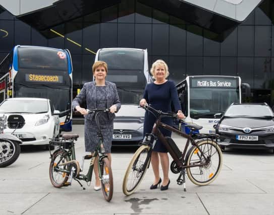 First Minister Nicola Sturgeon and Environment Secretary Roseanna Cunningham with vehicles whose engines would be clean enough for the low emission zones. Picture: John Devlin