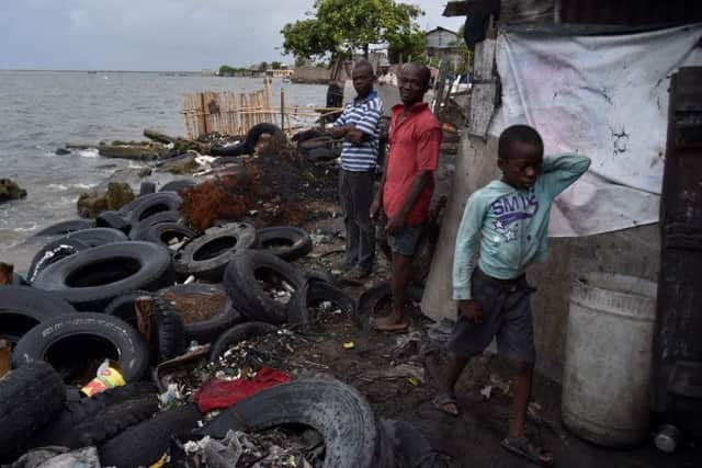 Jean (L) and Pierre( C) in the house where they work next to the sea in the neighborhood of Aviation, in Cap-Haitien on Haiti. Pic: Getty Images