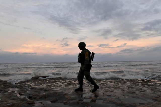A Mexican soldier who forms part of the national disaster program patrols the coast. Picture: AFP/Getty Images