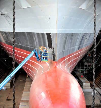 HMS Prince of Wales bow gets cleaned. Picture: Lisa Ferguson