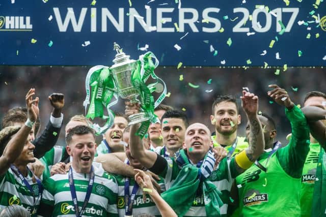Scott Brown (with trophy) has been an integral part of Celtic's success in recent years. Picture: John Devlin