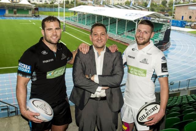 Finn Russell, right,with team-mate Fraser Brown, left, and Mark Cook, managing director of CDM, new sponsor of the east stand. Pictgure: SNS/SRU.