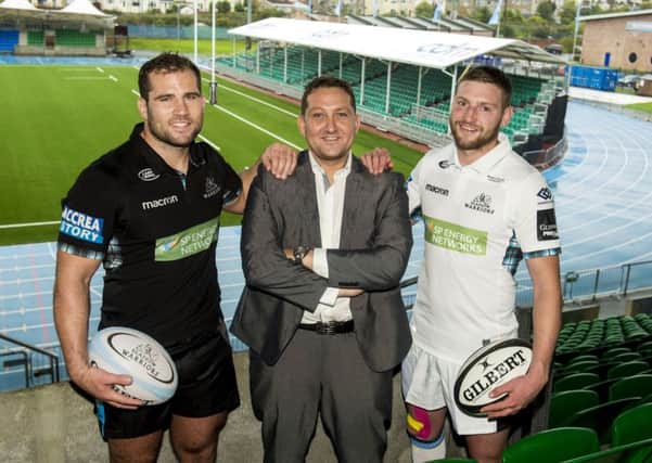 Finn Russell, right,with team-mate Fraser Brown, left, and Mark Cook, managing director of CDM, new sponsor of the east stand. Pictgure: SNS/SRU.