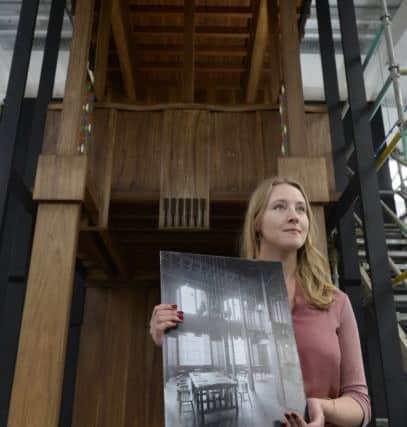 Architect Natalia Burakowska with a full size Tulip wood prototype section of the 1910 Charles Rennie MacKintosh designed library. picture: SWNS