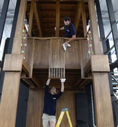 Master carpenters Angus Johnston and Martins Cirulis with a full size Tulip wood prototype section of the 1910 Charles Rennie MacKintosh. Picture: SWNS