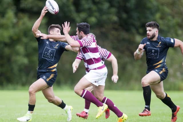 Curries Charlie Shiel evades the challenge of Watsonians Willie Thomson. Picture: SNS/SRU