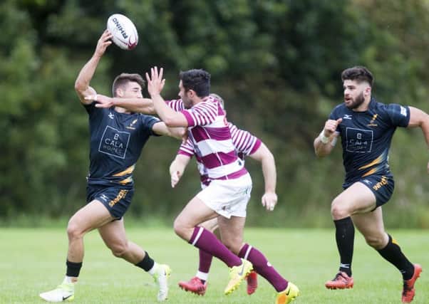 Curries Charlie Shiel evades the challenge of Watsonians Willie Thomson. Picture: SNS/SRU