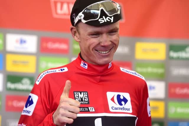 Chris Froome smiles as he sports the overall leaders red jersey after finishing third on the 20th stage of the Vuelta at Alto de LAngliru. Photograph: Jose jordan/AFP/Getty