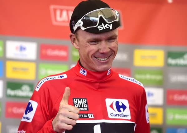Chris Froome smiles as he sports the overall leaders red jersey after finishing third on the 20th stage of the Vuelta at Alto de LAngliru. Photograph: Jose jordan/AFP/Getty