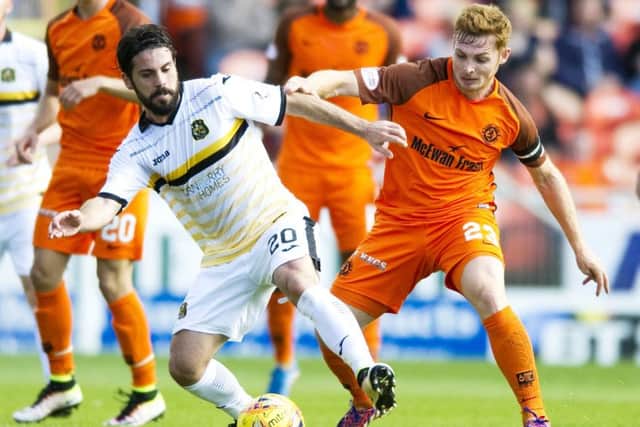 Dundee United's Fraser Fyvie battles with Dumbarton's Dimitris Froxylias. Picture: SNS/Garry Williamson