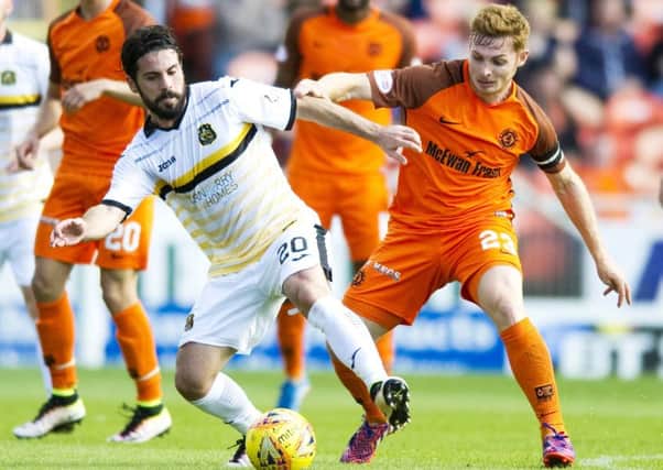 Dundee United's Fraser Fyvie battles with Dumbarton's Dimitris Froxylias. Picture: SNS/Garry Williamson