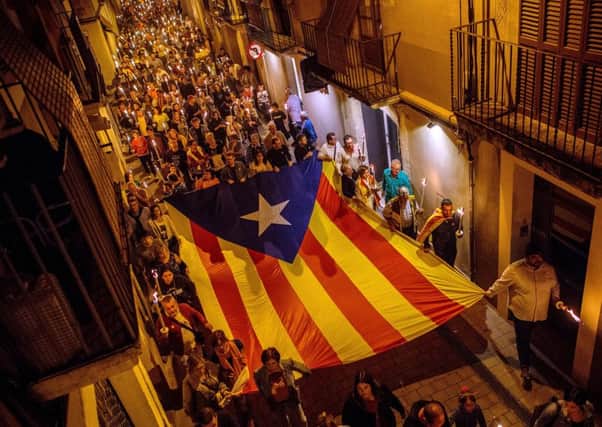 Demonstrators carry a big Catalan Independence flag as they march during a Catalan pro-independence demonstration on September 10 in Vilafranca del Penedes, Spain.   (Photo by David Ramos/Getty Images)