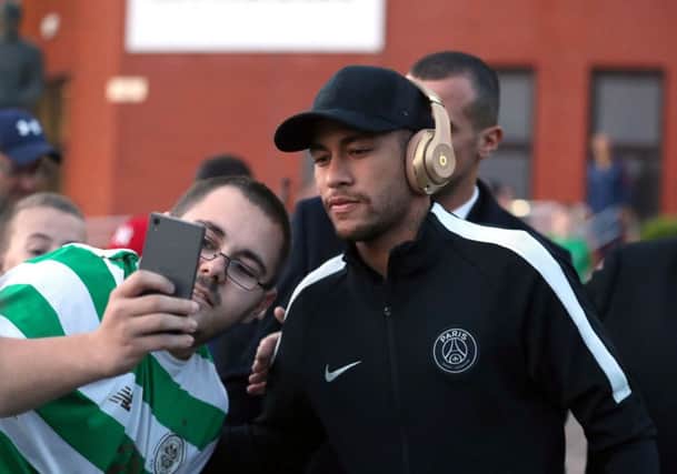 A Celtic fan takes a selfie with Neymar as Paris Saint-Germain arrive at Parkhead last night. Picture: PA