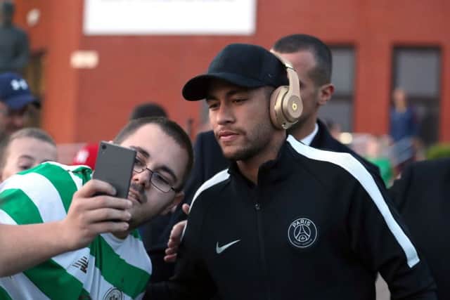 A Celtic fan takes a selfie with Neymar as Paris Saint-Germain arrive at Parkhead last night. Picture: PA