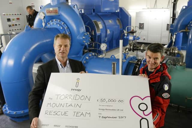 Torridon Mountain Rescue Team member Richard Cockburn accepts cheque from Hans Bunting, Chief Operating Officer, Renewables innogy SE, in the Grudie Hydro Electric scheme power station. Picture: Iain Ferguson/contributed