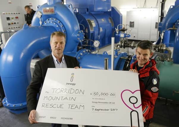 Torridon Mountain Rescue Team member Richard Cockburn accepts cheque from Hans Bunting, Chief Operating Officer, Renewables innogy SE, in the Grudie Hydro Electric scheme power station. Picture: Iain Ferguson/contributed