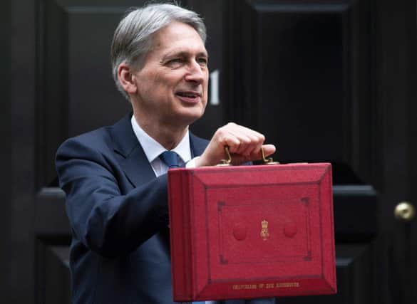Chancellor Philip Hammond poses for pictures as he prepares to unveil his Budget plans last year. Picture: Contributed