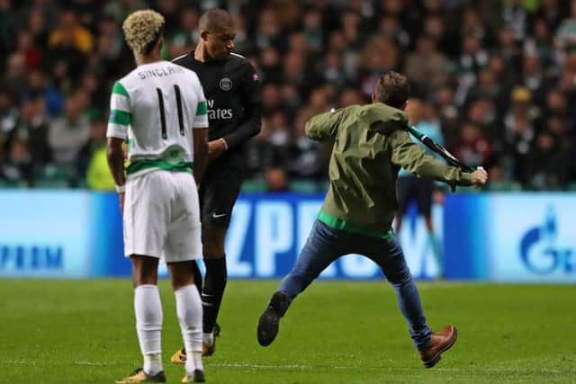 A fan runs by Paris Saint-Germain's Kylian Mbappe. Picture: Andrew Milligan/PA Wire