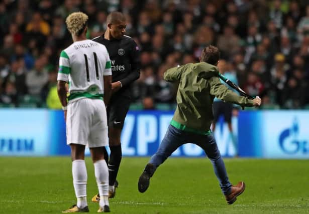 A fan runs by Paris Saint-Germain's Kylian Mbappe. Picture: Andrew Milligan/PA Wire