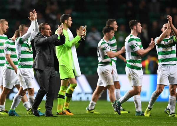 Brendan Rodgers and his players applaud the fans at full-time. Picture: AFP/Getty