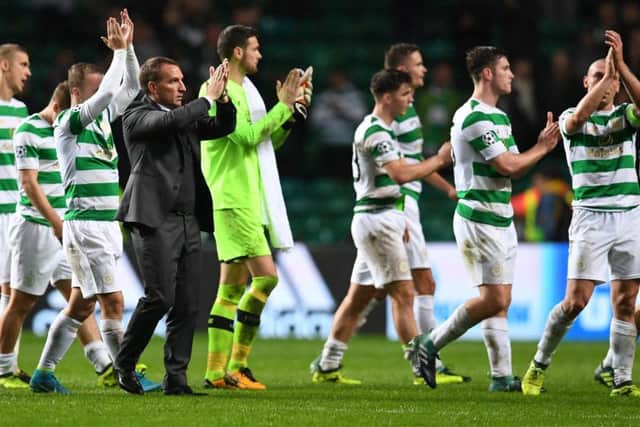 Brendan Rodgers and his players applaud the fans at full-time. Picture: AFP/Getty
