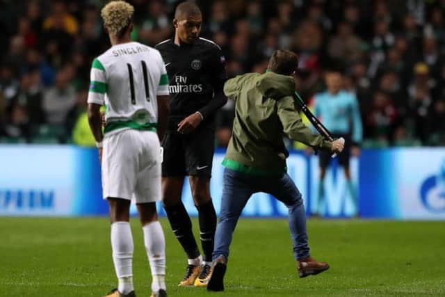 A fan ran on the park to confront PSG attacker Kylian Mbappe. Picture: PA