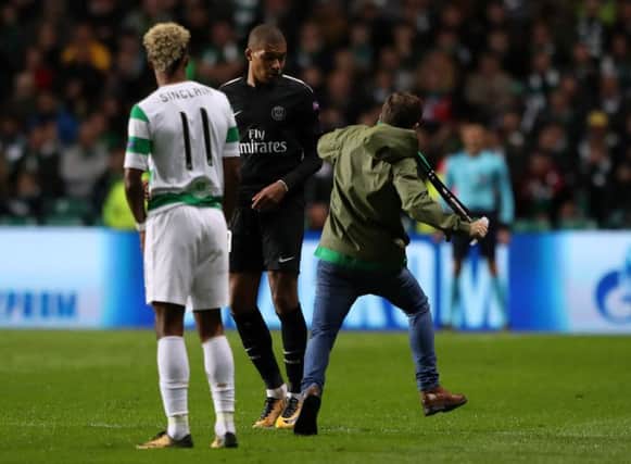 A fan ran on the park to confront PSG attacker Kylian Mbappe. Picture: PA