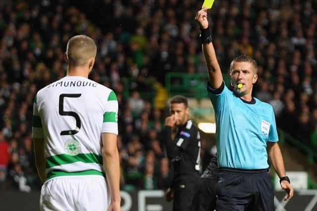 Jozo Simunovic is booked after bringing down Edinson Cavani. Picture: Getty