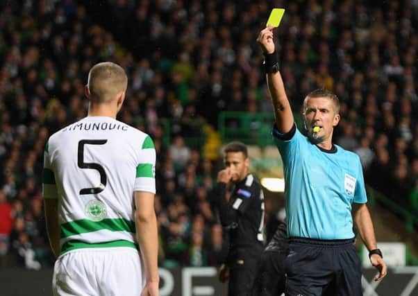 Jozo Simunovic is booked after bringing down Edinson Cavani. Picture: Getty