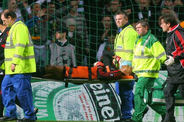 AC Milan's Brazilian goalkeeper Dida is taken off the pitch after being attacked by a Celtic fan. Picture: CARL DE SOUZA/AFP/Getty Images