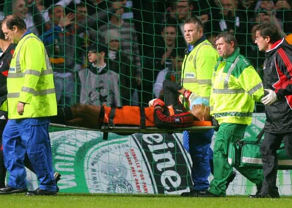 AC Milan's Brazilian goalkeeper Dida is taken off the pitch after being attacked by a Celtic fan. Picture: CARL DE SOUZA/AFP/Getty Images