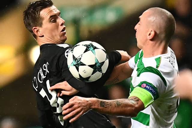 Scott Brown grapples with PSG's Giovani Lo Celso at Celtic Park.