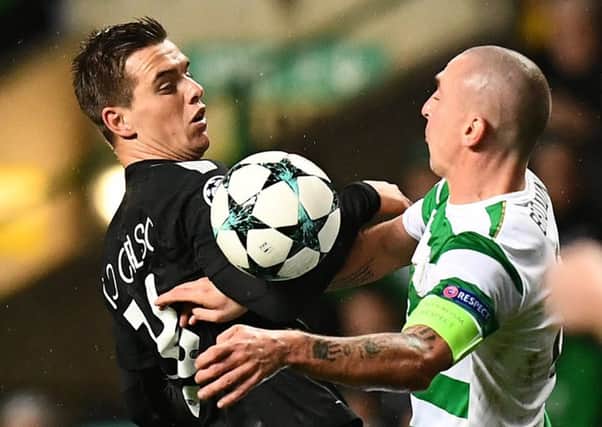 Scott Brown grapples with PSG's Giovani Lo Celso at Celtic Park.