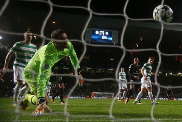 Craig Gordon of Celtic looks on in despair as Mikael Lustig scores an own goal during the Champions League  match against PSG.